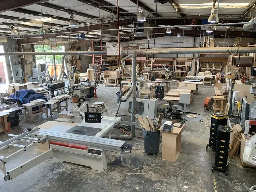 Panel saw and machinery on the Pohl Custom Cabinets shop floor