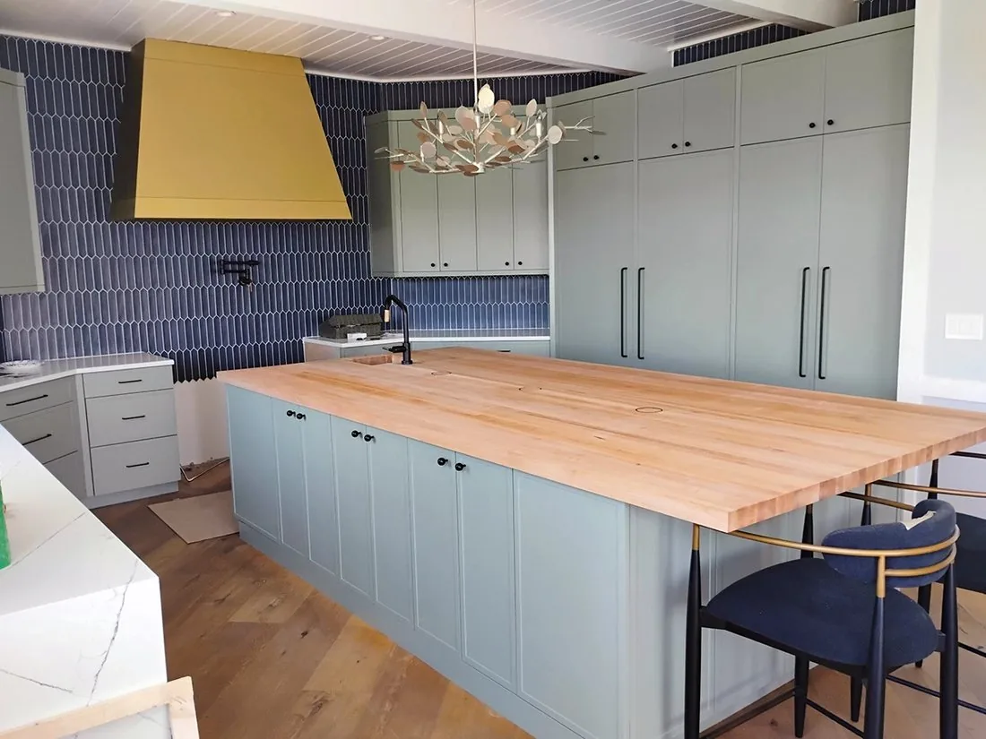 Coghlan bar and kitchen with butcher block island and tall cabinetry